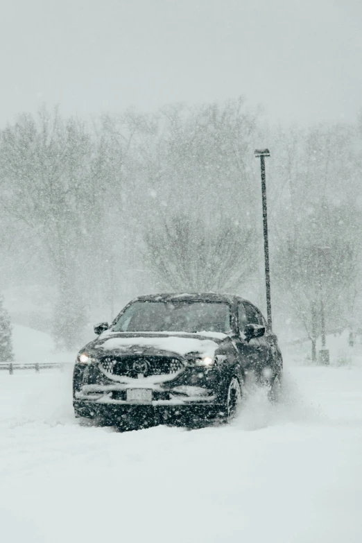 the car is driving in the snow on a street