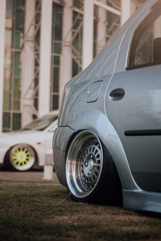 a car parked in front of a building near grass