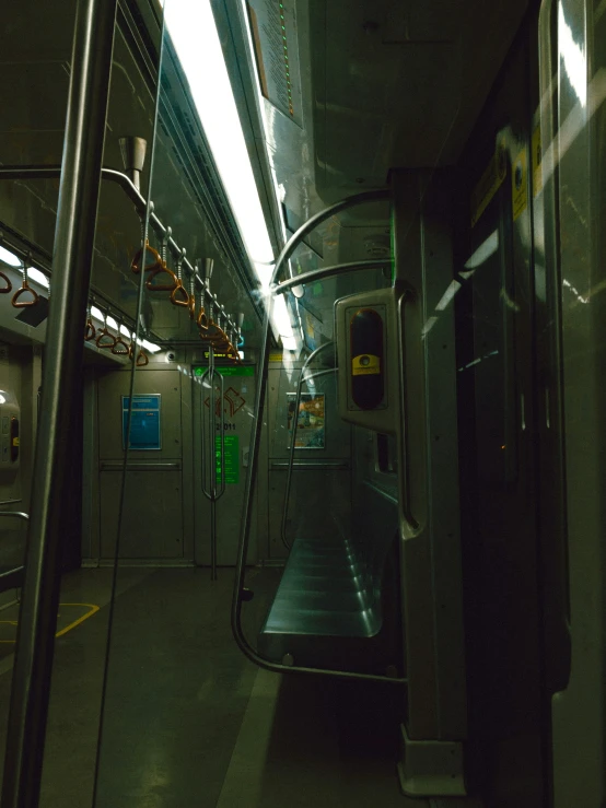 the subway is mostly empty at night, with it's lights on