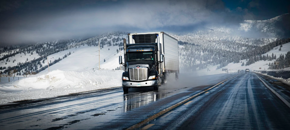 a big truck travels on the snowy road