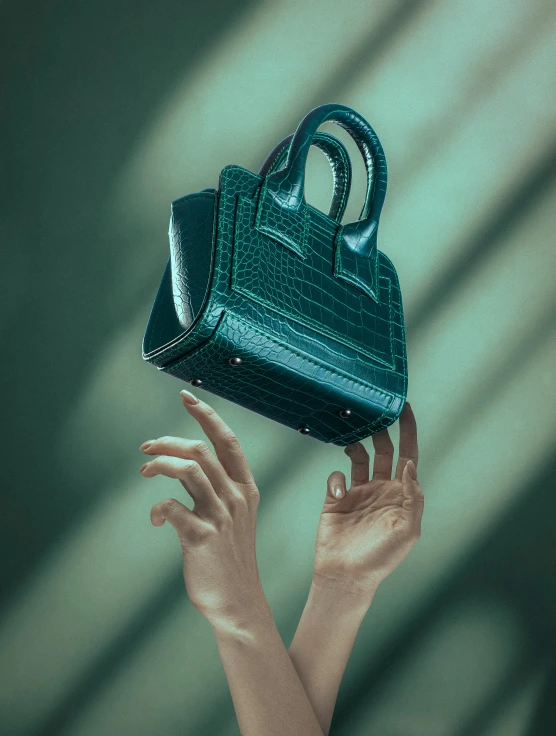 a green purse in a woman's hand