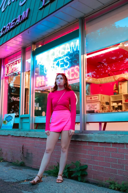 a woman posing outside a store with her hands on her hips