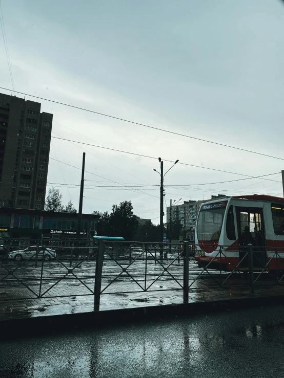 a tram passing on a rainy day in the city