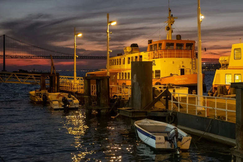 a boat is docked at a dock with some lights on