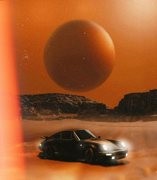 a car drives down a desert path with a giant planet in the background