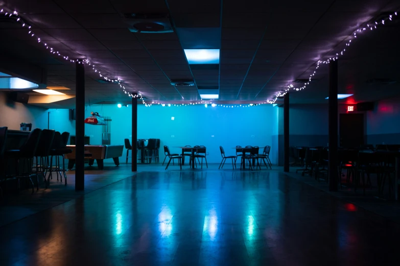 a banquet hall with dark furniture and lights