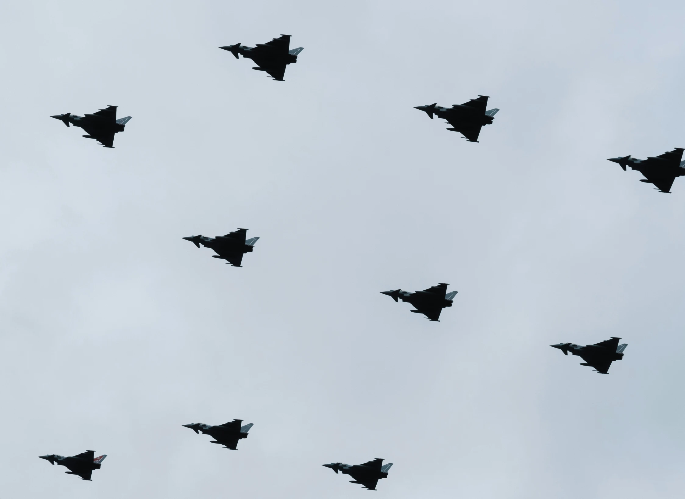 a number of fighter jets flying in formation