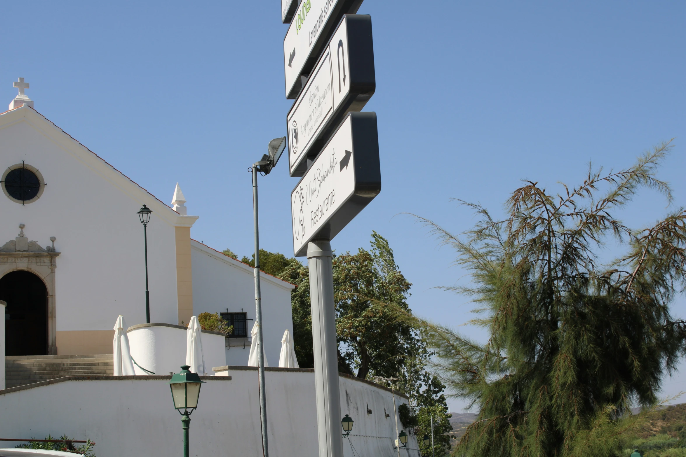 there is a street sign next to the entrance to the building