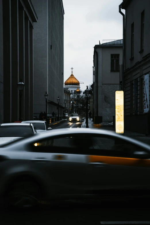 car passing through an intersection near tall buildings