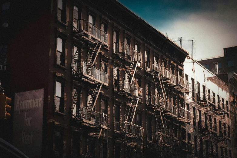 a building with lots of windows and ladders in front of it