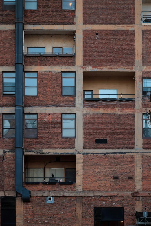 an outside view of the side of a building with balconies