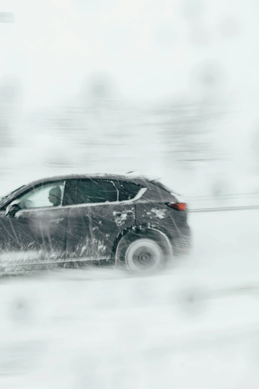 car driving in snow down the road in traffic