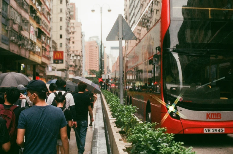 a line of people are walking up the steps to a bus