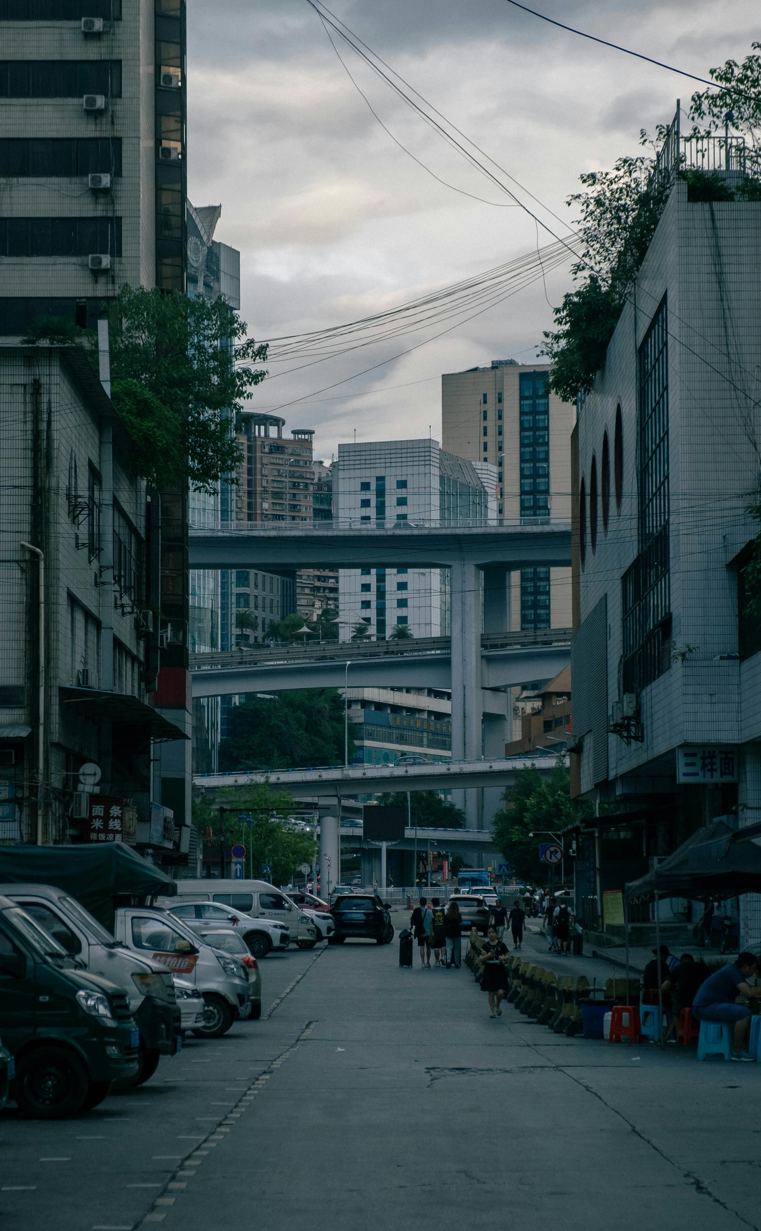 a city street filled with cars and tall buildings