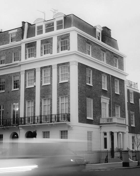 an old building with a black and white pograph on the outside