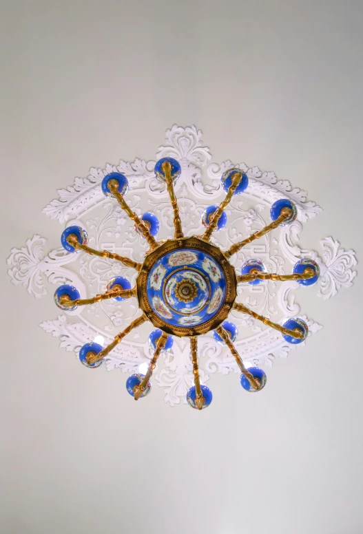 decorative glass light fixture with intricate carvings and blue and white lights