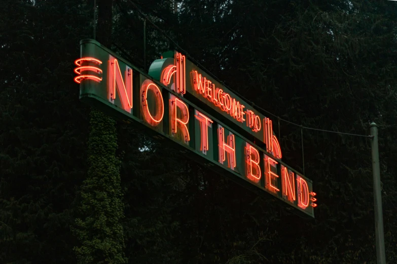 a neon sign that is hanging on the side of a building