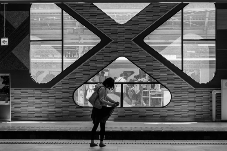 a person stands in front of a window on a building