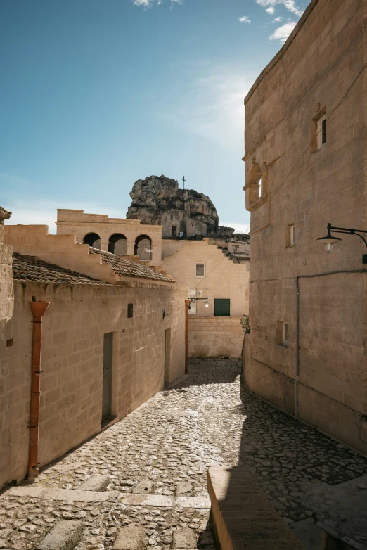 an alley with several stone buildings and windows