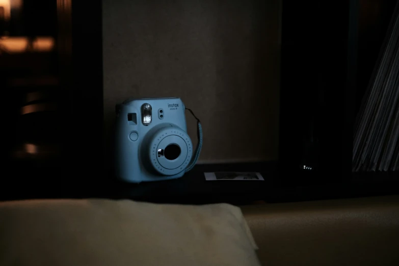 a camera sitting next to some records on a table