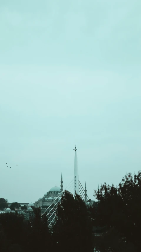 a plane flying in the sky over some buildings