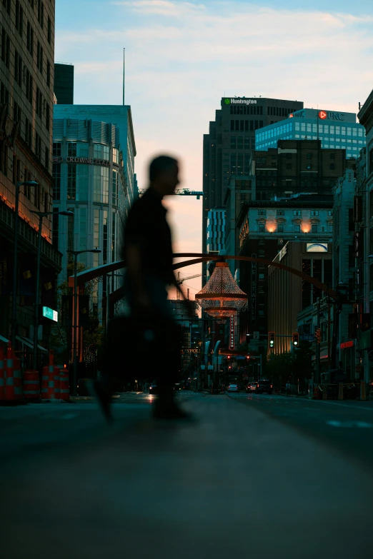 a man riding a skateboard down a street at night