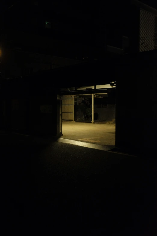 an empty garage at night with the light on