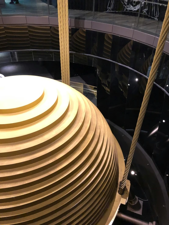 a large round object in a room with glass walls