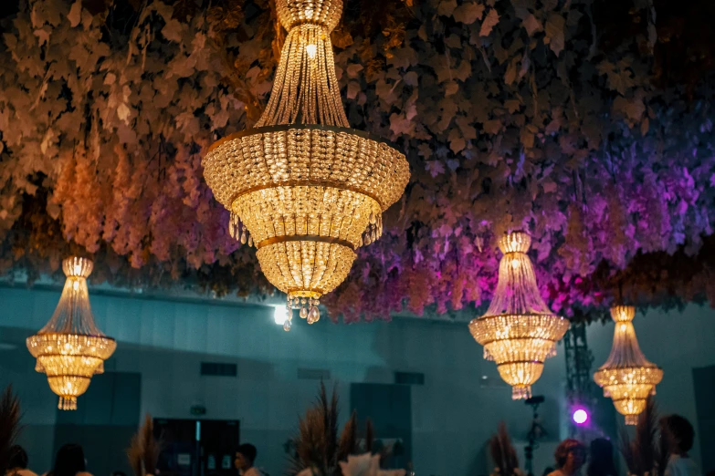 an elaborate chandelier at a party next to a crowd