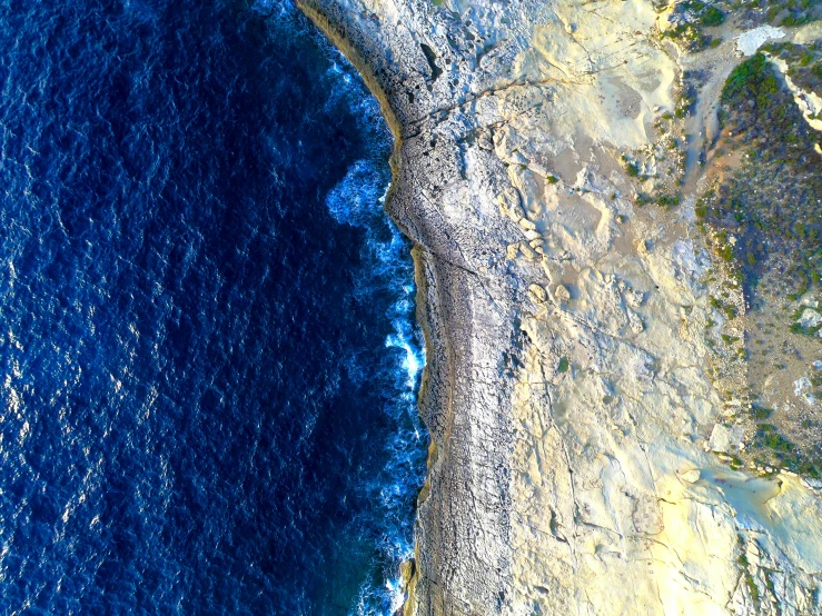 an aerial view of a mountain and ocean