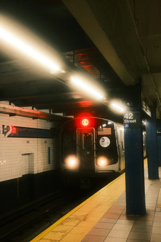 the train is approaching on the tracks at the station