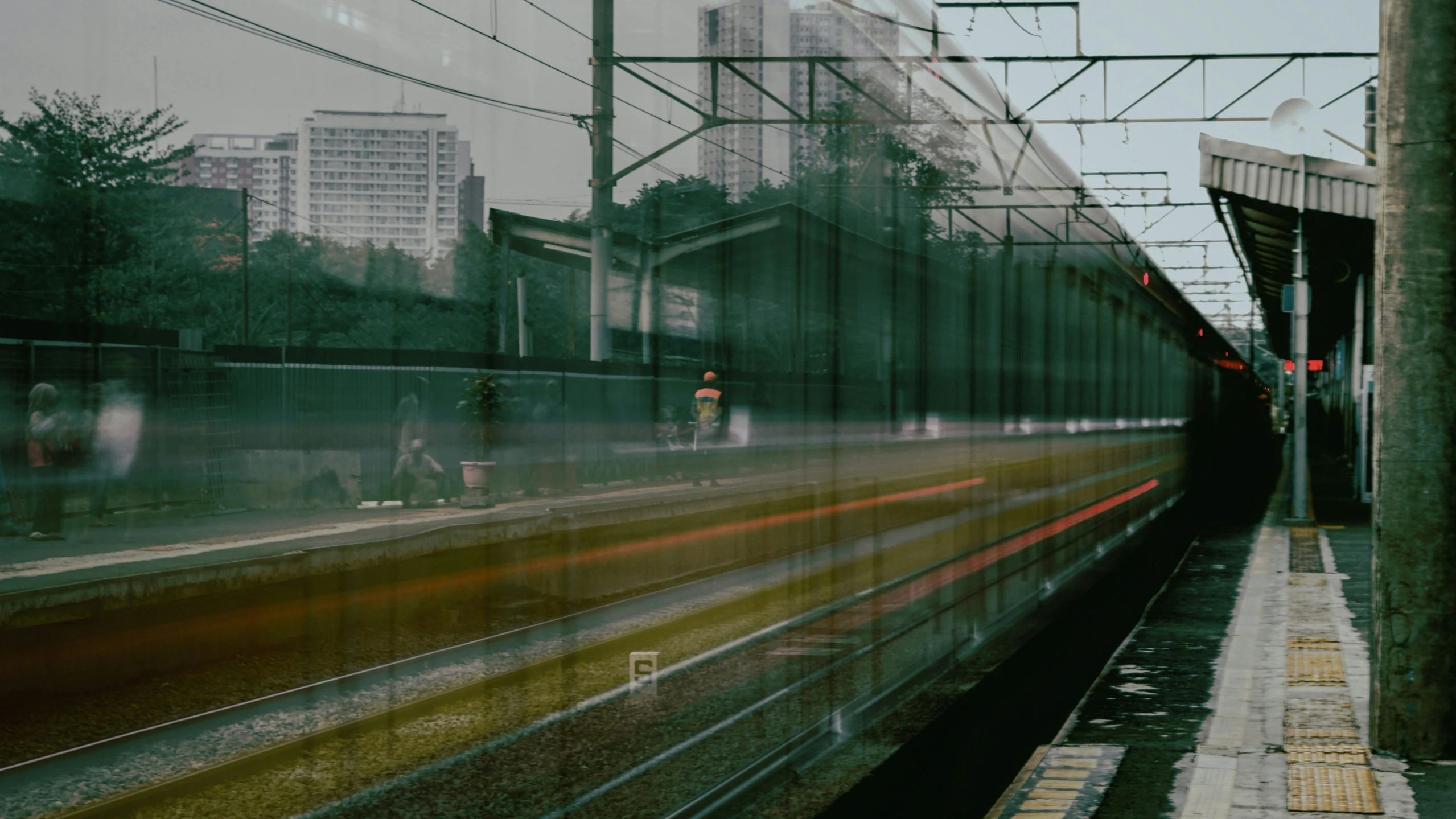 the reflection in a train window of some buildings