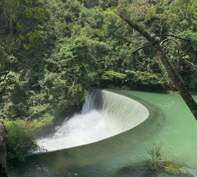 a wave in the water near a waterfall