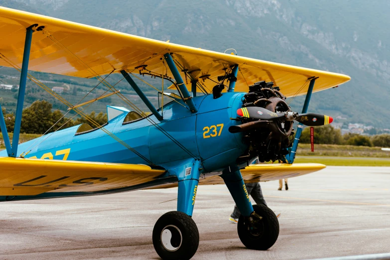 an antique blue and yellow biplane with two engines