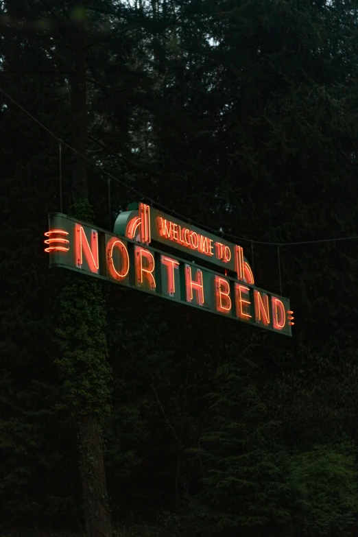 the large sign has neon lettering and red light