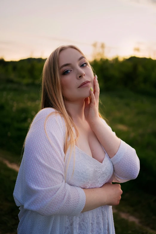 a young lady poses for a pograph outdoors