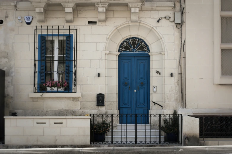 a blue door is on a tan building