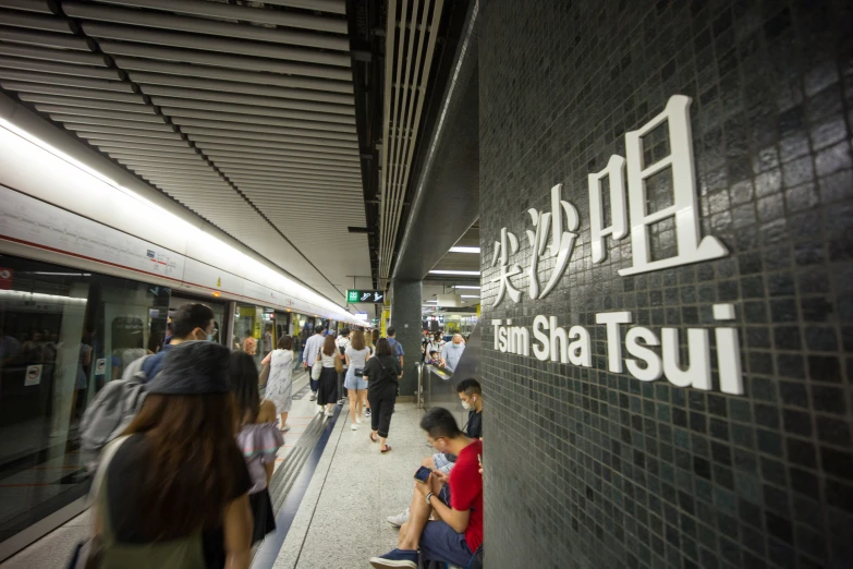 a group of people are sitting near a train