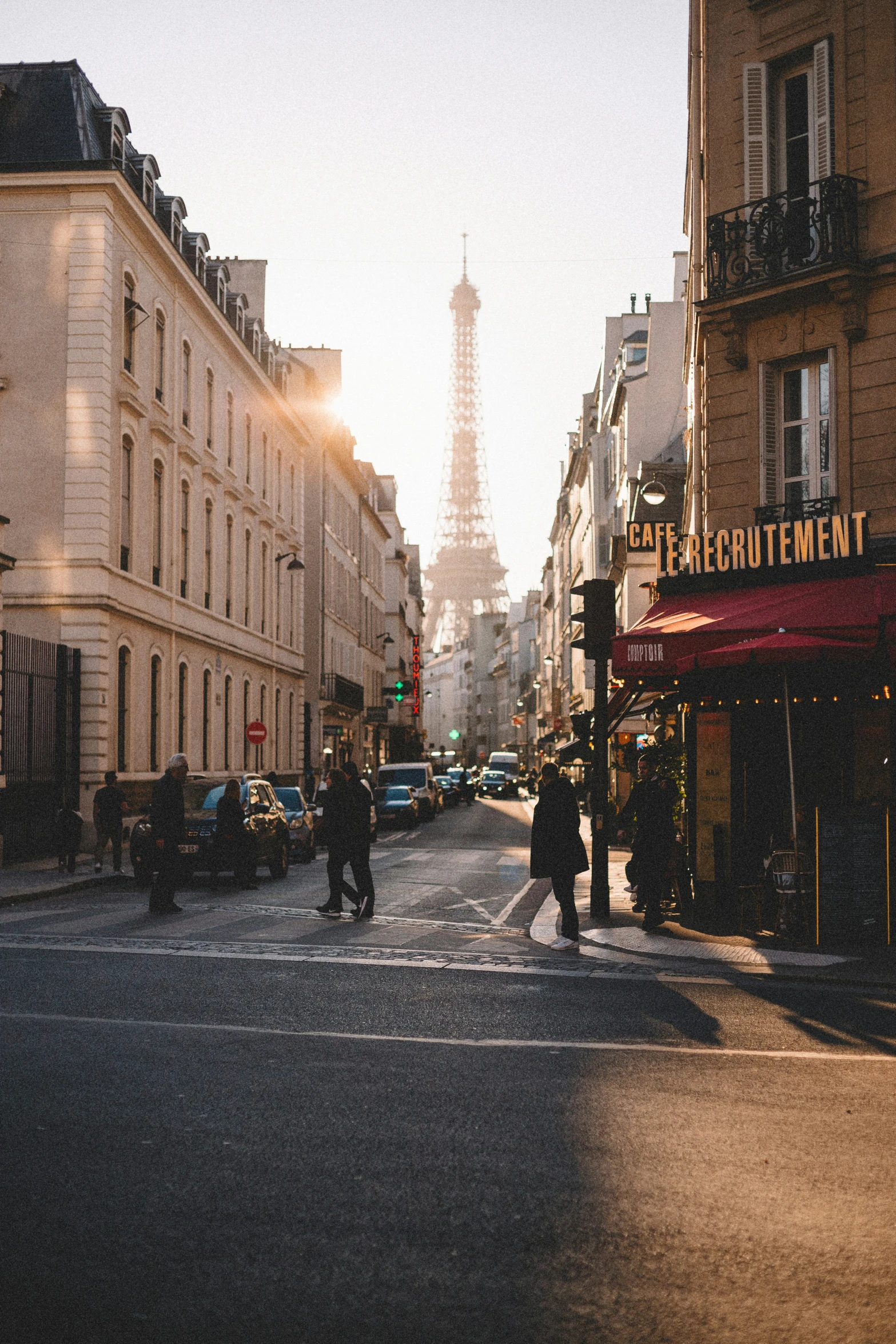 the sun is shining on the buildings in the street