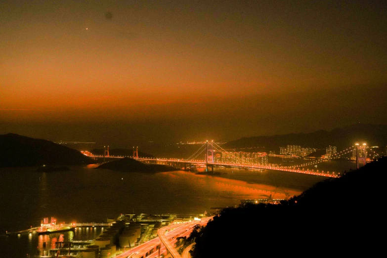 a nighttime s shows a bridge, bay and the ocean