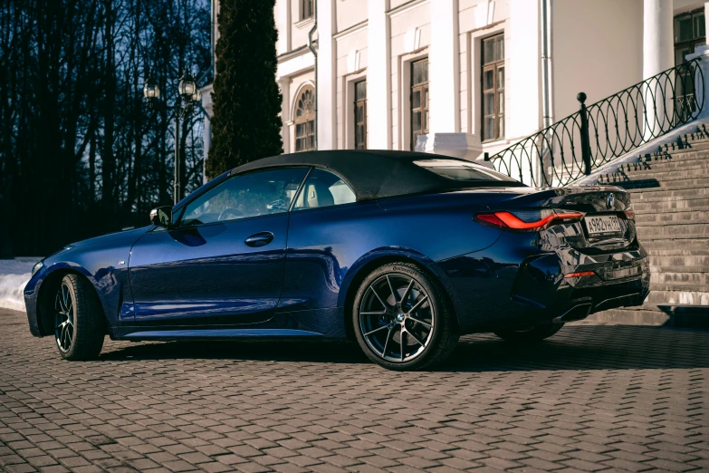 a blue sports car parked on the street