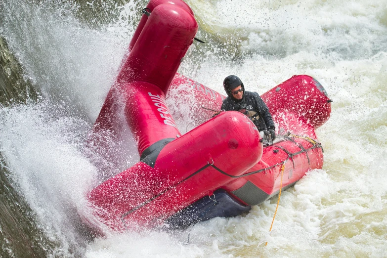 a man on a raft with the oar up close