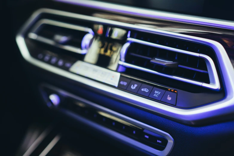 a car interior with a blue light around the center console