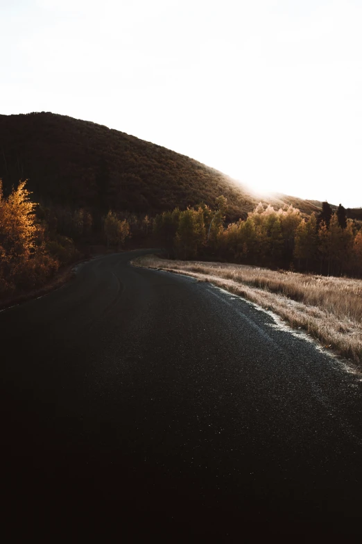 a road with a hill in the background