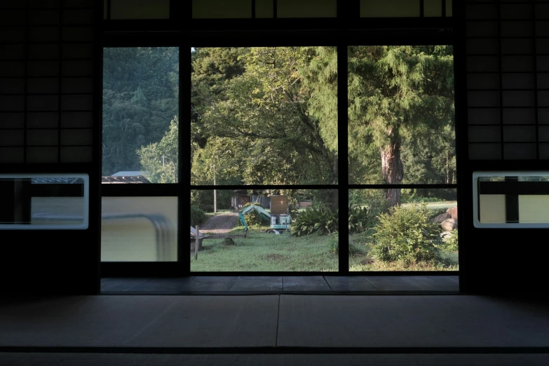 a large open window looks out over a field