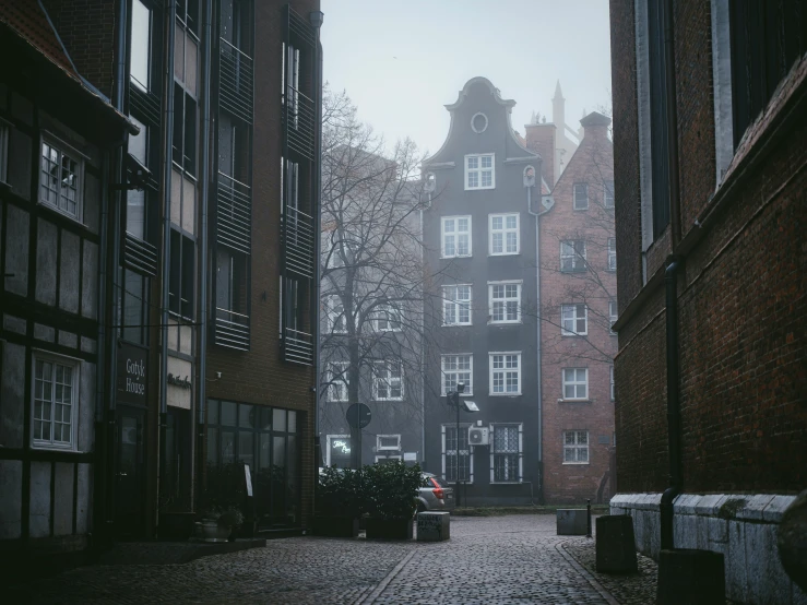 a dark city street with tall buildings