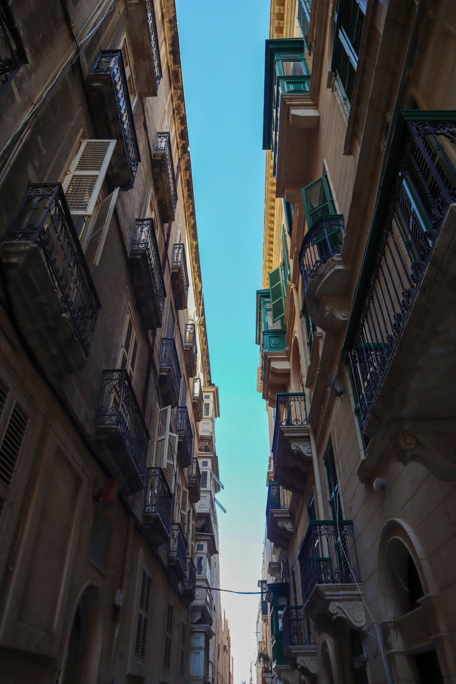 looking up at several different styles of balconyed building