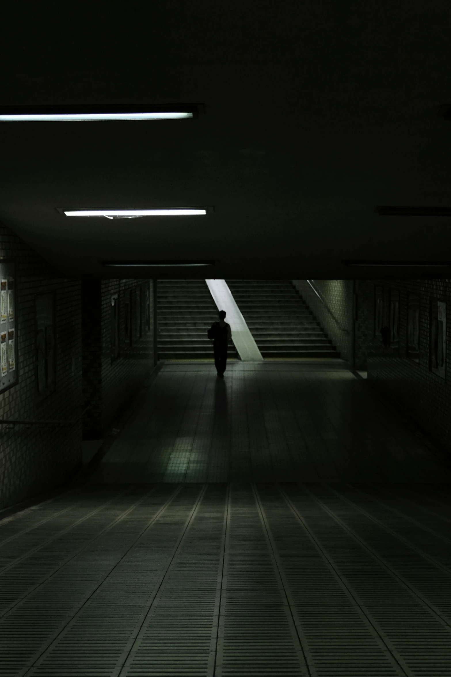 man standing alone in the dark looking for a light