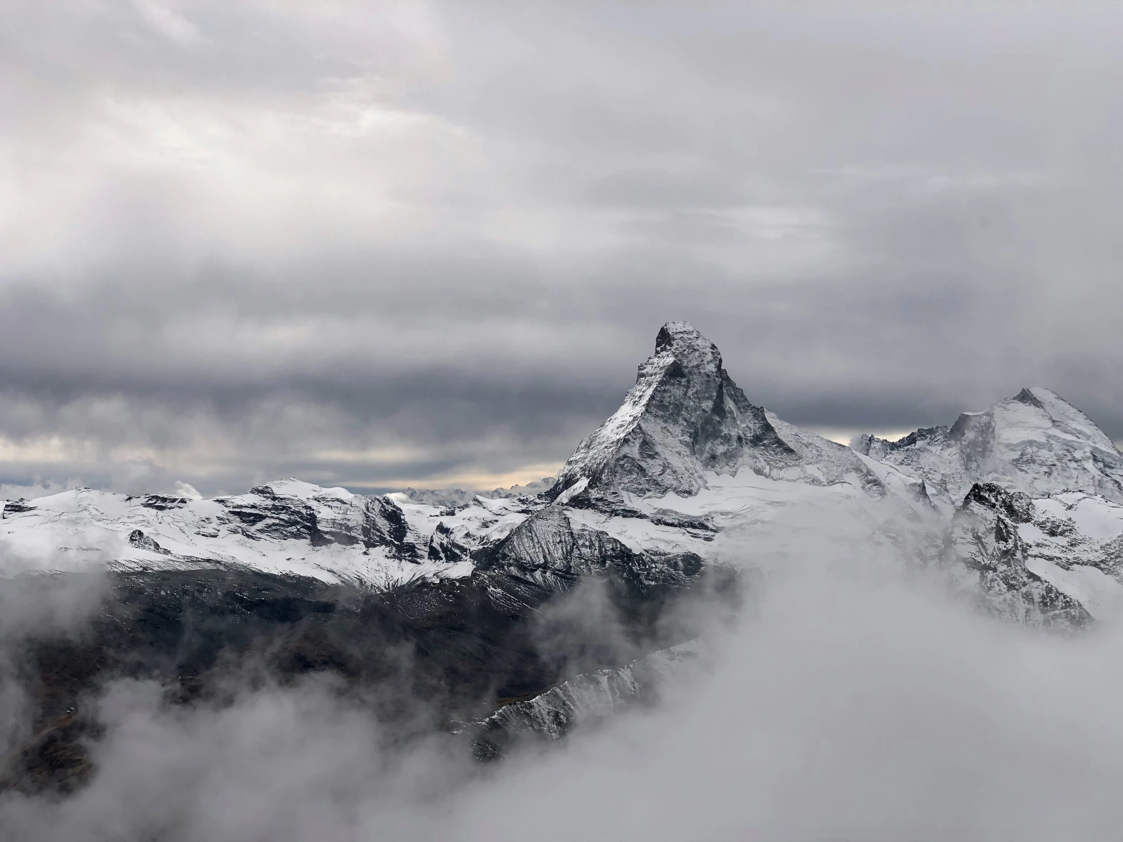 the peaks of the mountains look out over clouds