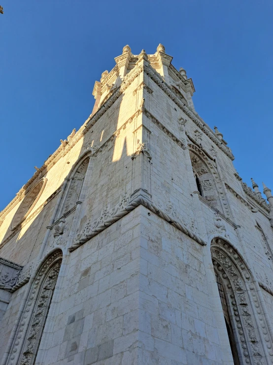 the large brick tower has several windows and decorative ornaments